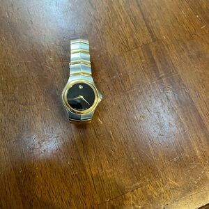 Used Luxury Movado Women’s Gold and Black Watch- has scratches
